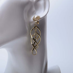 Golden twist hoop earrings for women's accessories by Bentati Fashion Dubai